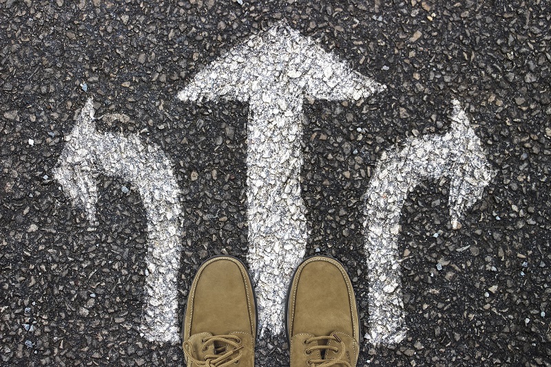 Feet on pavement with arrows