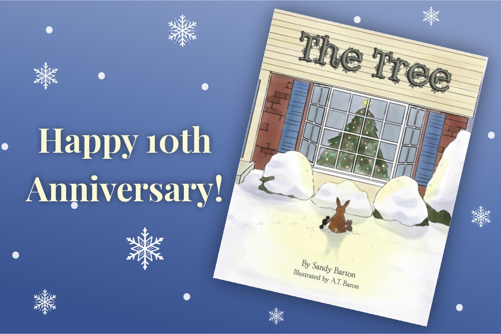 A book cover titled "The Tree" shows two animals facing a decorated Christmas tree seen through a window. Text on the left reads, "Happy 10th Anniversary!" on a blue background with snowflakes scattered around.